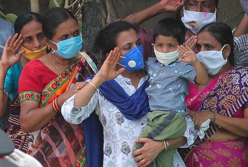 Santoshi and her son salute during the last rites of her husband in Suryapet. AP Photo