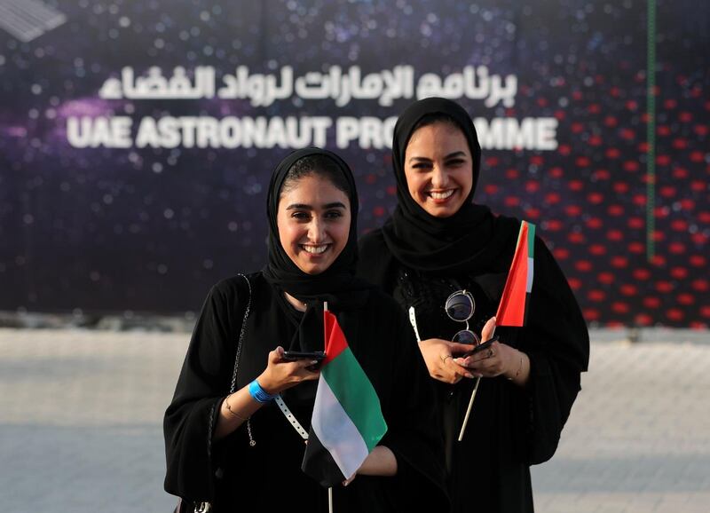 People attend a live screening of the launch of the UAE's first astronaut into space, at Mohammed bin Rashid Space Centre in Dubai. Chris Whiteoak / The National