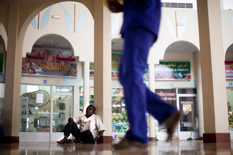 July 13, 2011, Ras Al Khaimah, UAE:

Abdul Khadr takes his breaks on the floor of a mall. Working outside is not a picinc in the summertime, but life must go on, and with it work. Here Abdul looks up at a shopkeeper (the blue uniform is for a local food store) who walks back to his work, which is inside of the mall.

Lee Hoagland/The Naional