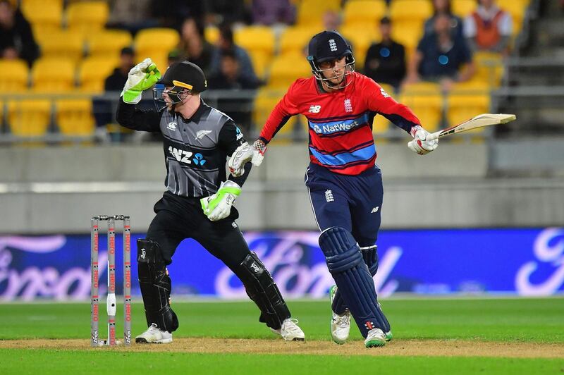 England's Alex Hales (R) makes a run as New Zealand's wicketkeeper Tim Seifert (L) reacts during the first Twenty20 cricket match between New Zealand and England at Westpac Stadium in Wellington on February 13, 2018. / AFP PHOTO / Marty MELVILLE