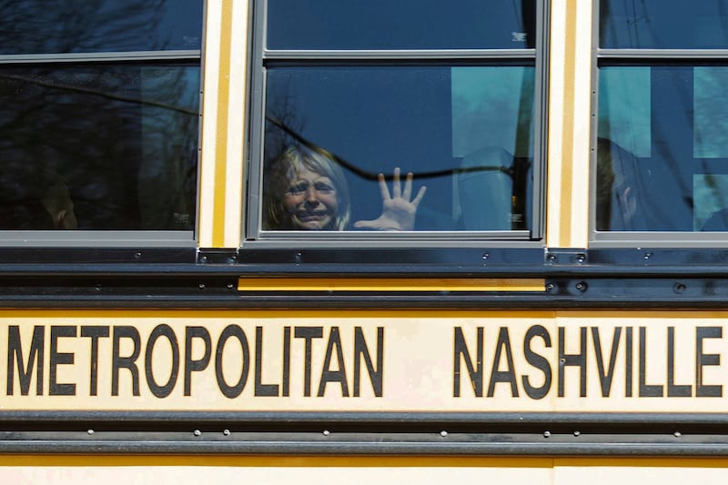 A child weeps while on the bus leaving The Covenant School in Nashville, Tennessee, following a mass shooting on March 27. Reuters