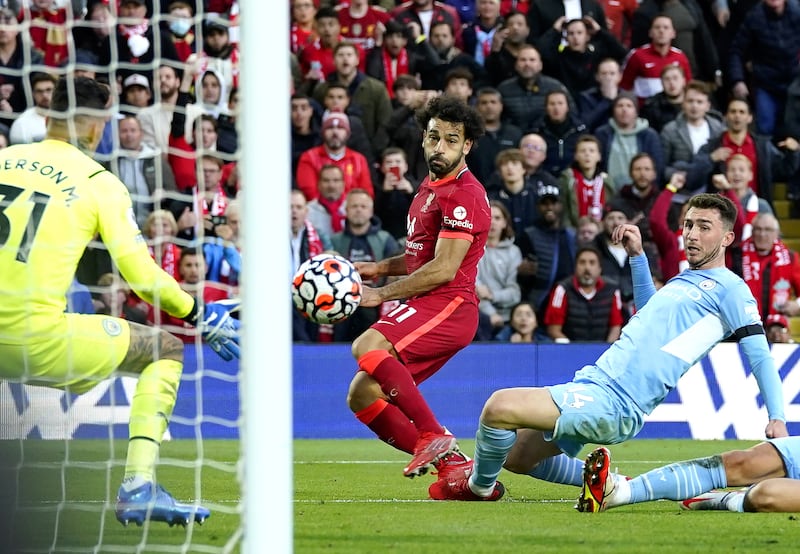 Mohamed Salah scores Liverpool's second goal in their 2-2 Premier League draw with Manchester City at Anfield on Sunday, October 3. EPA