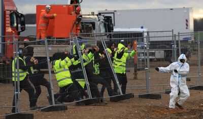 Activists try to knock down a fence near the open-cast mine in western Germany. AP 