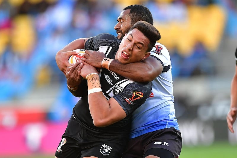 New Zealand's Joseph Tapine is tackled by Fiji's Henry Raiwalui during the Rugby League World Cup quarter-final match at Westpac Stadium in Wellington. Marty Melville / AFP Photo