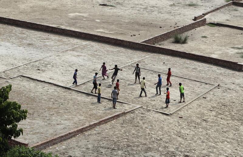 Bangladeshi children play football, on plots marked to build houses in Savar, on the outskirts of Dhaka, Bangladesh. Football fans around the world are gearing up to watch the upcoming World Cup football tournament in Brazil. A.M. Ahad / AP 
