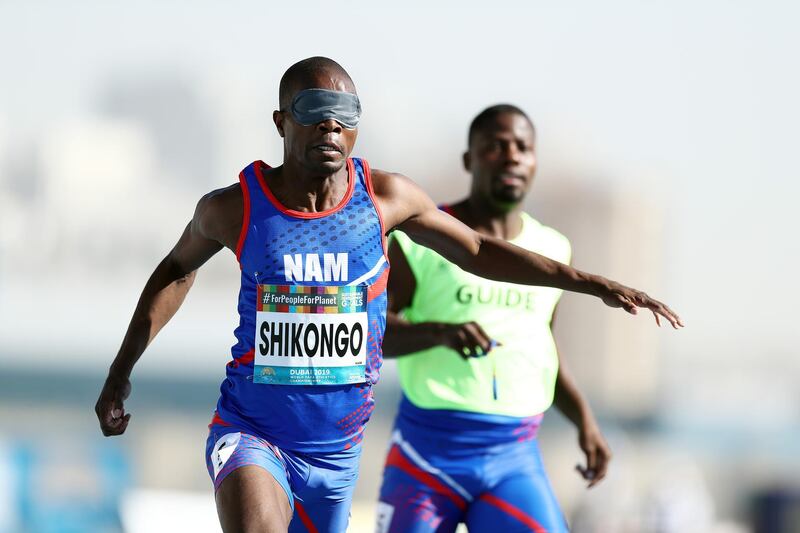 DUBAI, UNITED ARAB EMIRATES - NOVEMBER 12:  Ananias Shikongo of Namibia and guide Even Tjiviju competes in the Men's 100m T11 during Day Six of the IPC World Para Athletics Championships 2019 Dubai on November 12, 2019 in Dubai, United Arab Emirates. (Photo by Bryn Lennon/Getty Images)