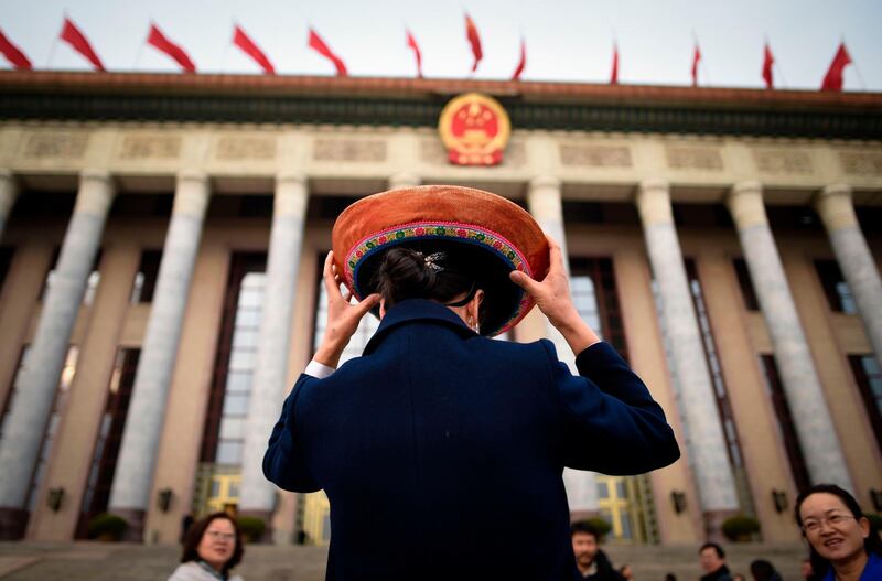 A delegate arrives for the Qinghai delegation meeting at the Great Hall of the People during the National People's Congress, China's legislature in Beijing. Wang Zhao / AFP Photo