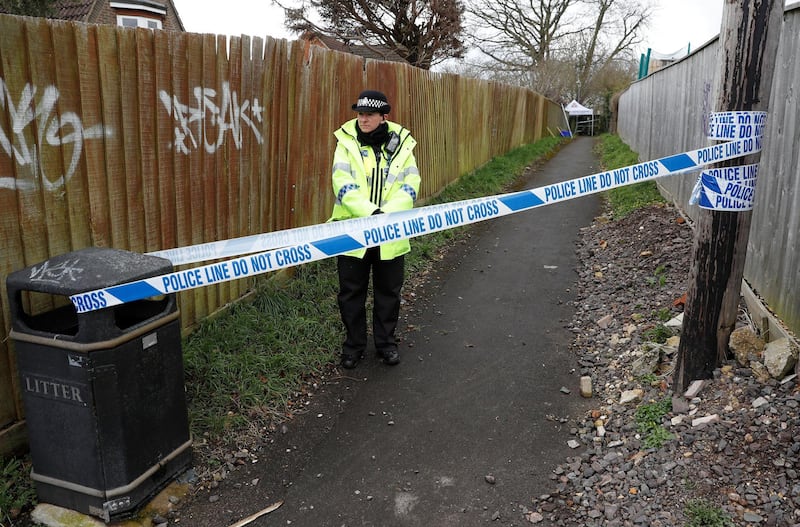 A police officer stands behind cordon tape in an alleyway which has been blocked off near the home of former Russian intelligence officer Sergei Skripal in Salisbury, Britain, March 28, 2018. REUTERS/Peter Nicholls