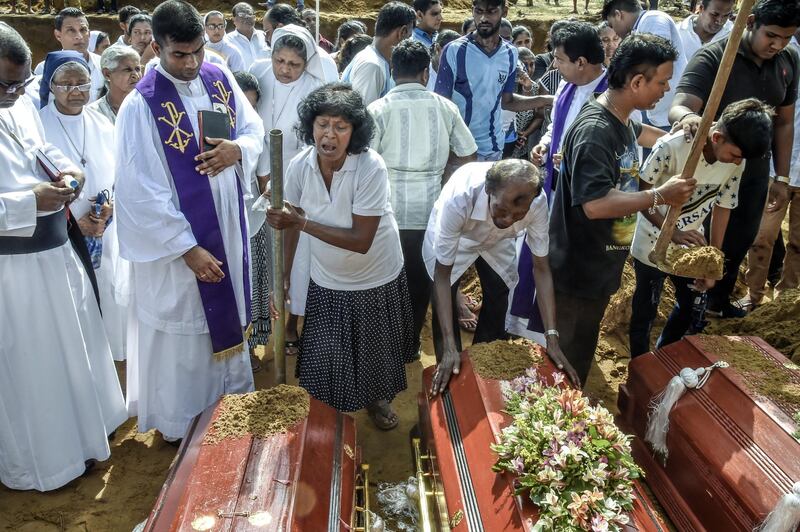 COLOMBO, SRI LANKA - APRIL 23: Relatives of the dead offer their prayers during funerals in Katuwapity village on April 23, 2019 in Negambo, Sri Lanka. At least 311 people were killed with hundreds more injured after coordinated attacks on churches and hotels on Easter Sunday rocked three churches and three luxury hotels in and around Colombo as well as at Batticaloa in Sri Lanka. Sri Lankan authorities declared a state of emergency on Monday as police arrested 24 people so far in connection with the suicide bombs, which injured at least 500 people as the blasts took place at churches in Colombo city as well as neighboring towns and hotels, including the Shangri-La, Kingsbury and Cinnamon Grand. (Photo by Atul Loke/Getty Images)