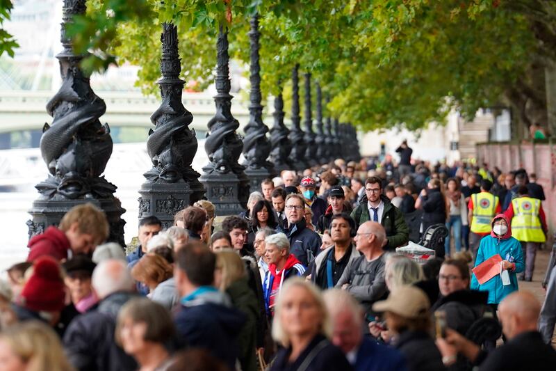 People join the queue on the South Bank in London to view Queen Elizabeth II lying in state. AP