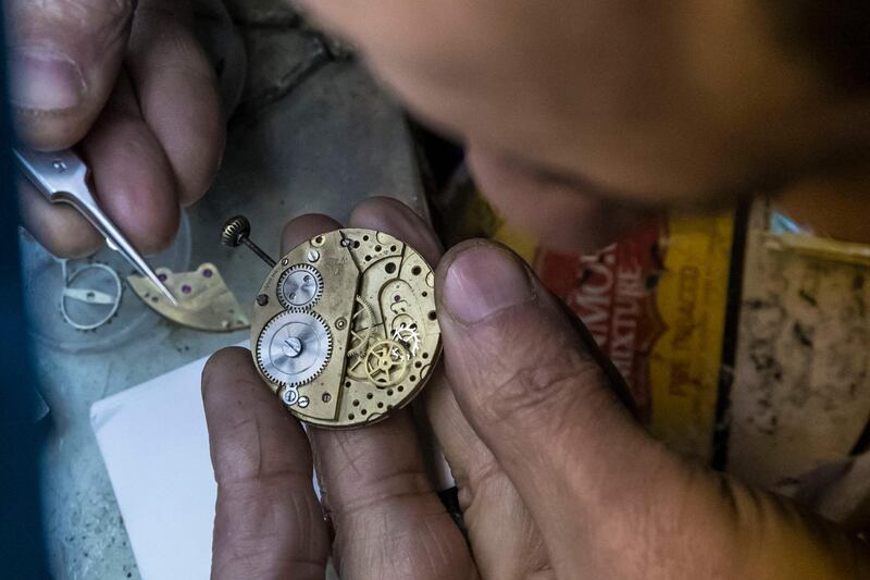 Refaat Makary at work in the historic Armenian watchmaker shop in Cairo. AFP