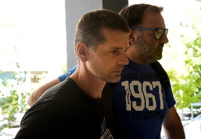 FILE PHOTO: Alexander Vinnik, a 38 year old Russian man (L) suspected of running a money laundering operation, is escorted by a plain-clothes police officer to a court in Thessaloniki, Greece July 26, 2017. REUTERS/Alexandros Avramidis/File Photo