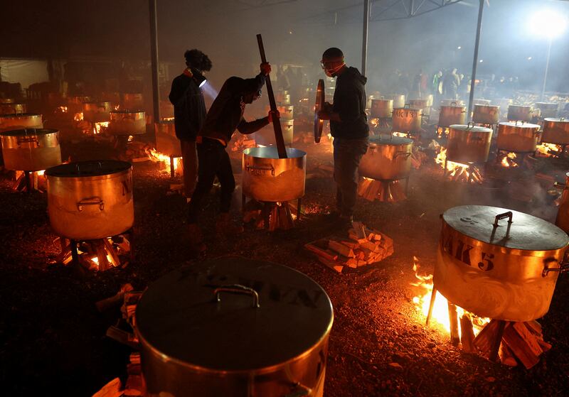 Volunteers from Cape Town's NGO Nakhlistan help to prepare more than 180 pots of food for less fortunate families to celebrate the end of Ramadan, in South Africa. Reuters