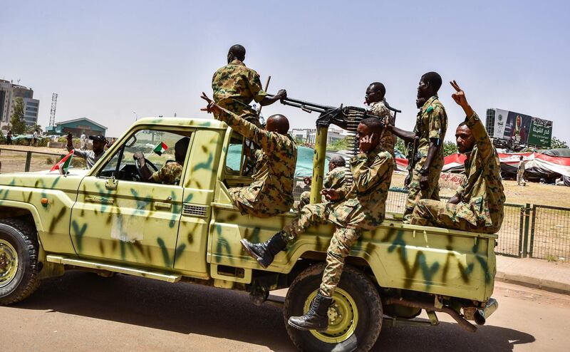 Sudanese soldiers flash the victory gesture.  AFP