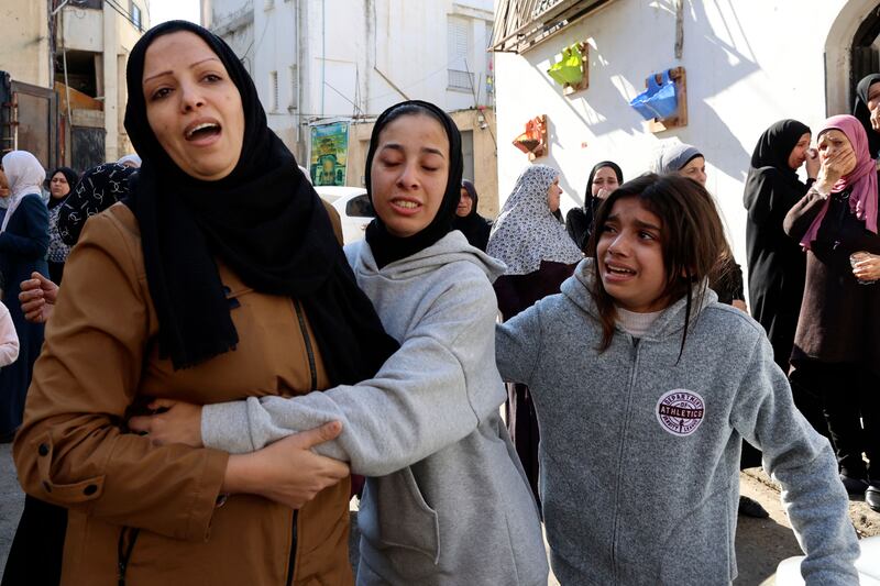 Relatives mourn during the funeral in the occupied West Bank. AFP