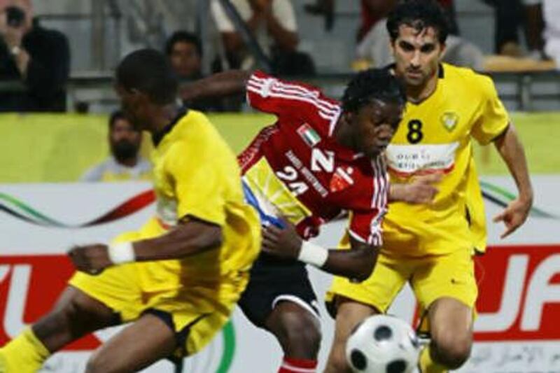 Naser Masoud of Al Jazira is felled during their victory over Al Shaab on Friday night.
