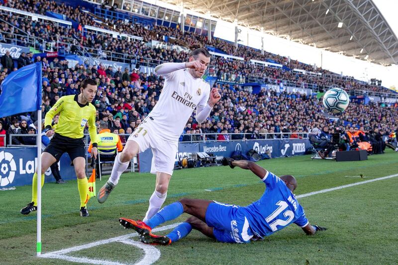 Getafe's defender Allan Nyom, right, fouls Real Madrid's Gareth Bale. EPA
