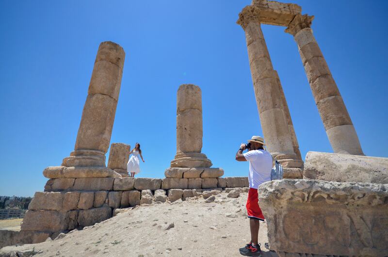 A tourist poses for a picture at Amman Citadel.