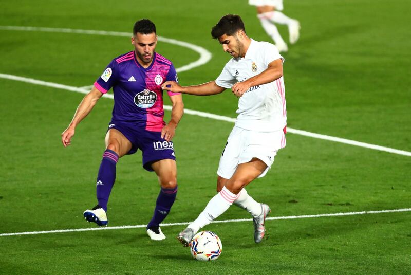 Real Madrid's Marco Asensio in action with Real Valladolid's Bruno. Reuters