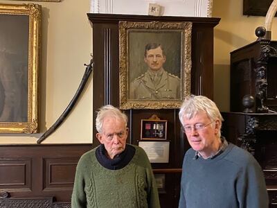 Godfrey Meynell with his son, Godfrey, and a portrait and the bravery medals of his father, also Godfrey. Mark Souster / The National