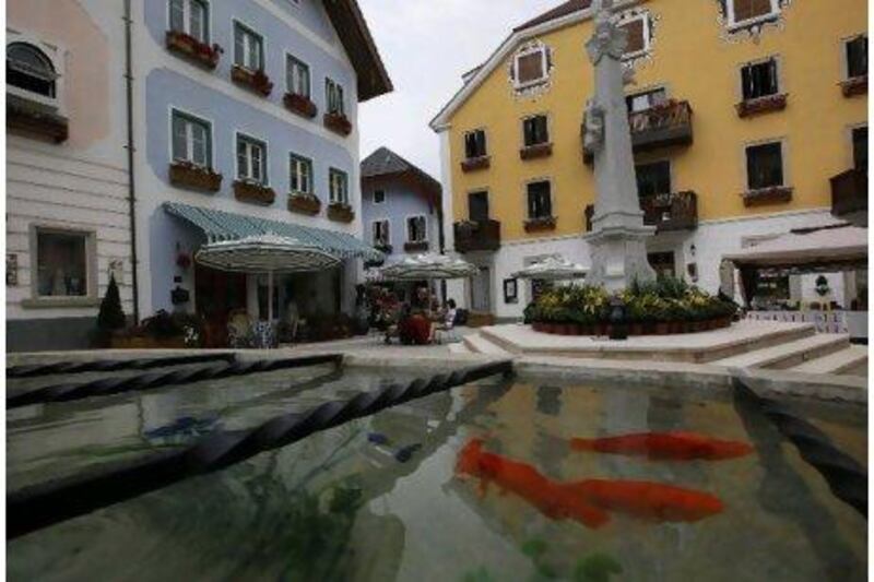 There are fish swimming in the pond at an European-style houses in Hallstatt See, a replica of the Austrian town of Hallstatt, in Boluo county, Huizhou city, south China's Guangdong province. AP Photo