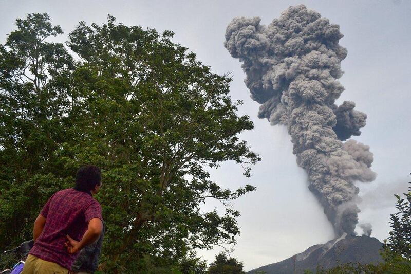 A man watches as Mount Sinabung continues to erupt, with hot smoke spewing from the volcano, in the Karo district on the north of Indonesia’s Sumatra island. Sutanta Aditya / AFP Photo