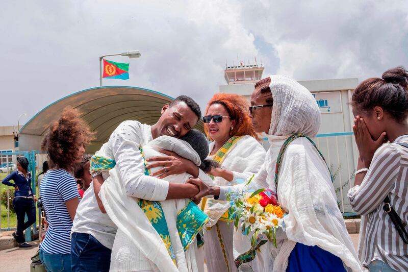 Medhane Berhane cries while meeting his mother and family at the Asmara International airport July 21, 2018 when he sets foot in the Eritrean capital Asmara for the first time in 18 years. Ethiopia and Eritrea resumed commercial airline flights on July 18, 2018 for the first time in two decades after resuming diplomatic ties after 20-year-stand off.  / AFP / Maheder HAILESELASSIE TADESE
