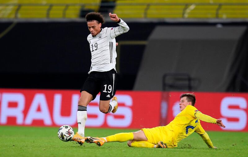 Leroy Sane attempts to avoid a challenge from Ukraine defender Eduard Sobol. AFP