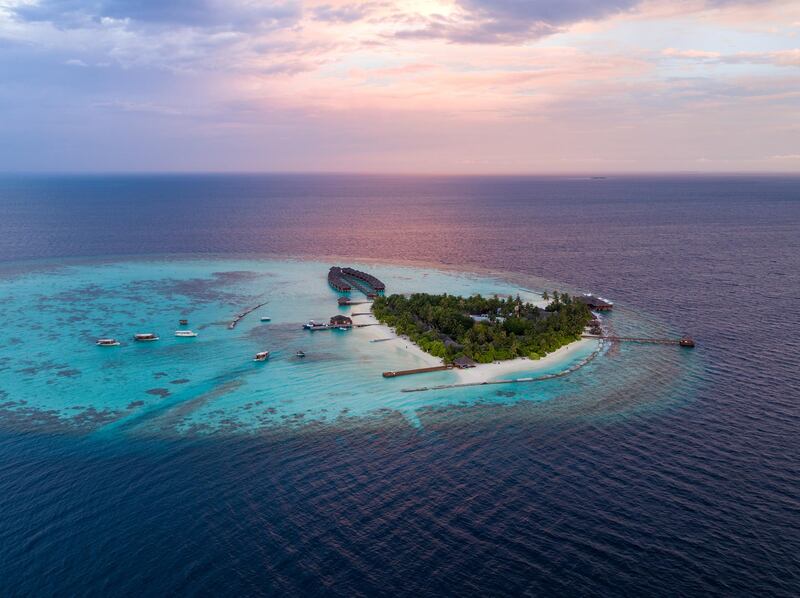 Aerial drone view of a tropical island at sunset, Maldives. Getty Images