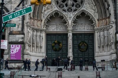 Police officers detain a man who opened fire outside the Cathedral Church of St. John the Divine in the Manhattan borough of New York City, New York, U.S., December 13, 2020 REUTERS/Jeenah Moon