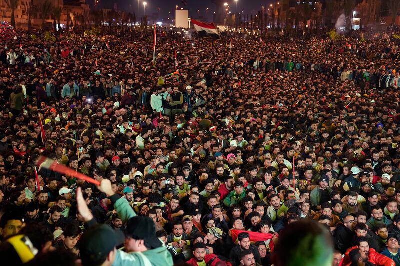 Iraqi fans watch the Arabian Gulf cup final on a big screen at Tahrir Square in Baghdad. AP