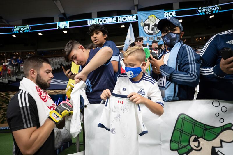 Vancouver Whitecaps goalkeeper Maxime Crepeau signs autographs before his team's match against Los Angeles FC in Vancouver, Canada. AP