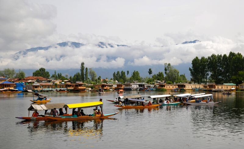 Indian tourists enjoy a shikara ride across the waters of Dal Lake in Srinagar, the summer capital of Indian Kashmir. Farooq Khan / EPA