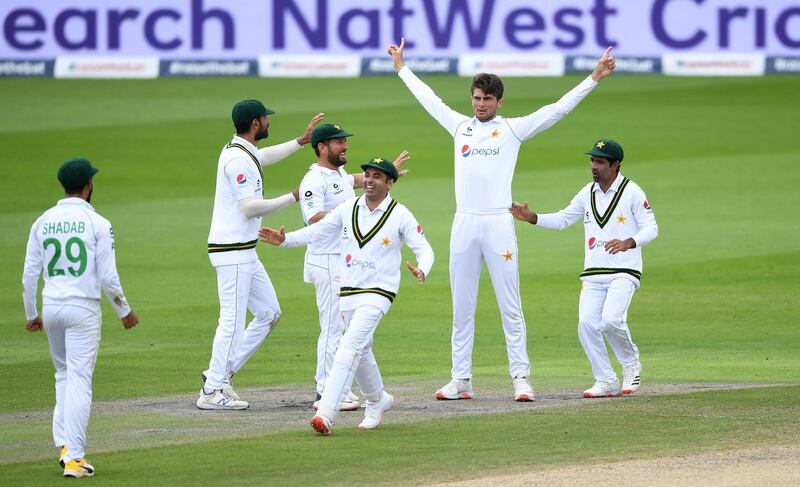 Shaheen Afridi of Pakistan celebrates with teammates after taking the wicket of Ollie Pope in Manchester. Getty