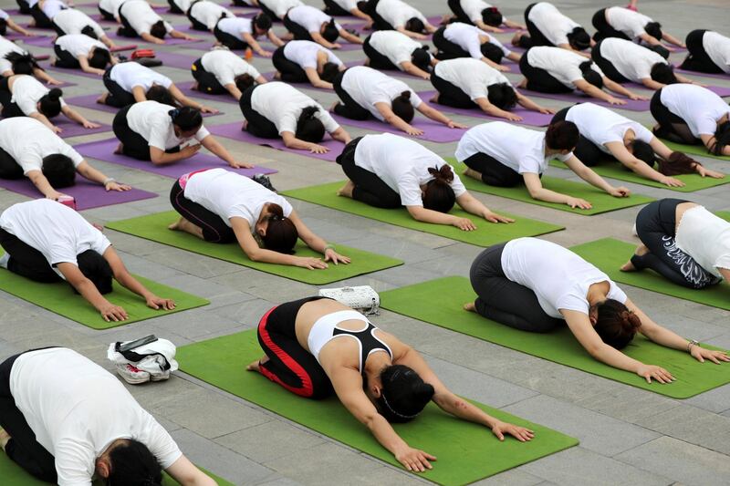 People practice yoga in Xiangyang, Hubei province, China.  Reuters