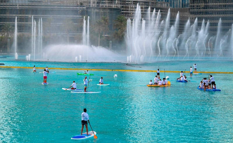 People paddle boarding in the Burj Khalifa fountain. Karim Sahib / AFP