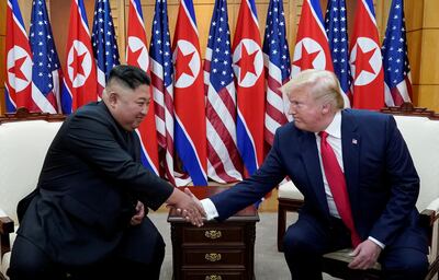 FILE PHOTO: U.S. President Donald Trump shakes hands with North Korean leader Kim Jong Un as they meet at the demilitarized zone separating the two Koreas, in Panmunjom, South Korea, June 30, 2019. REUTERS/Kevin Lamarque/File photo