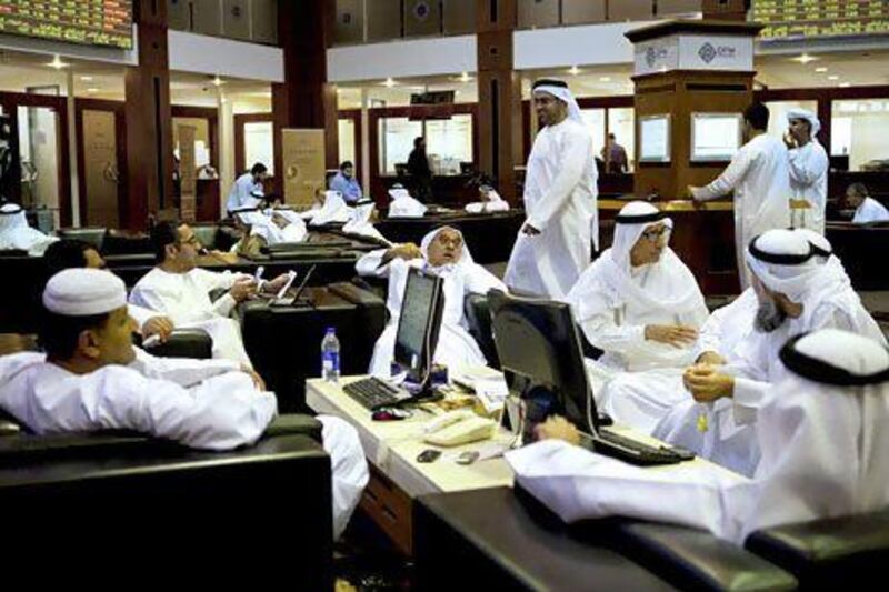 Traders at the Dubai Financial Market in the World Trade Centre. The UAE is under review next week for a potential upgrade from its current frontier status by MSCI. Christopher Pike / The National