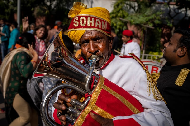 A brass band member plays as BJP supporters celebrate election results at the party headquarters in New Delhi. AP Photo