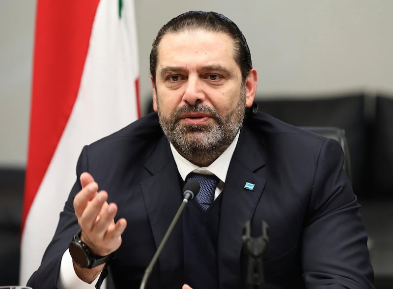 In this photo released by Lebanese government, Lebanese outgoing Prime Minister Saad Hariri gestures during his meeting with his parliamentary bloc, in Beirut, Lebanon, Thursday, Dec. 19, 2019. Lebanon's President Michel Aoun was holding long-delayed talks with parliamentary blocs Thursday to discuss the naming of a new prime minister amid an unprecedented political and economic crisis and weeks of nationwide protests roiling the country. (Dalati Nohra via AP)