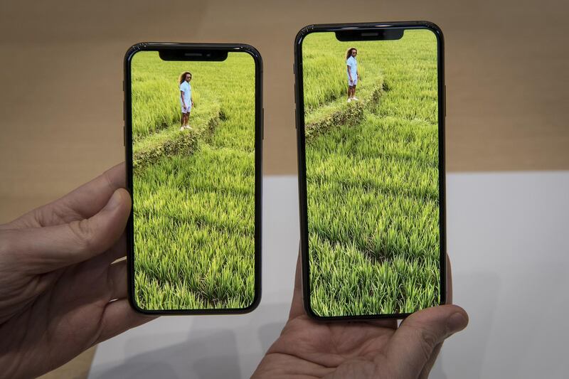 An attendee displays the Apple Inc. iPhone XS Max, right, and iPhone XS. David Paul Morris / Bloomberg