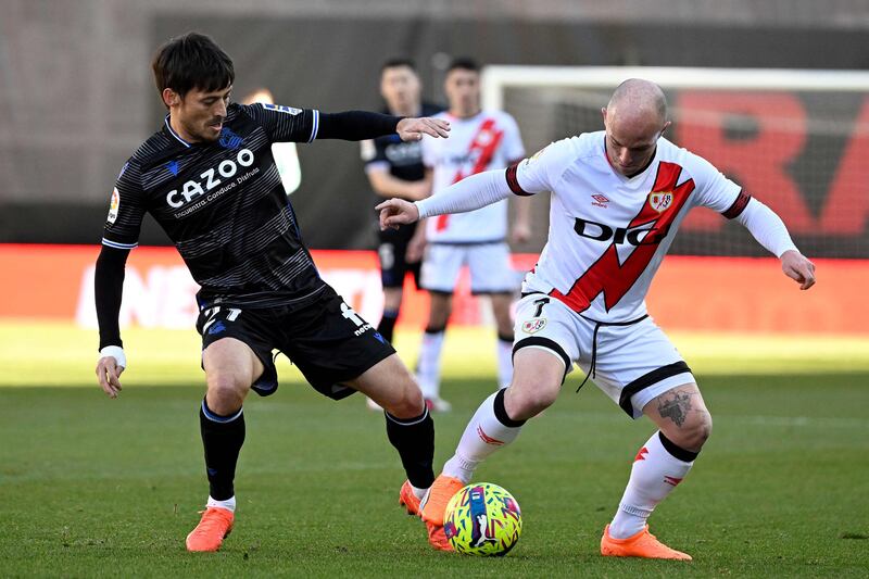Real Sociedad's David Silva battles with Rayo Vallecano's Isi Palazon. AFP
