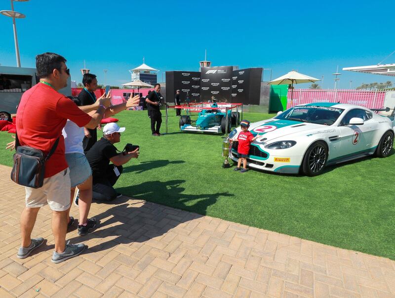 Abu Dhabi, U.A.E., November 23, 2018.  
Family day at the Main Grandstand area at the Yas Marina Circuit.  A little boy posses infront of a YAS Marina Circuit pace car.
Victor Besa / The National
Section:  NA
Reporter: