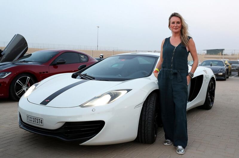 DUBAI, UNITED ARAB EMIRATES, August 31 – 2018 :- Joanne Doran with her Mclaren car at the Dubai Autodrome in Dubai. Members and Guests of the Ninth Degree supercars club driving their cars during the Ninth Degree supercars club meet held at Dubai Autodrome in Dubai. ( Pawan Singh / The National )  For Motoring. Story by Adam Workman