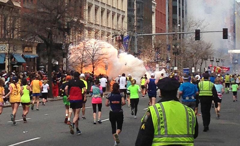 Runners continue to run towards the finish line of the Boston Marathon as an explosion erupts near the finish line of the race in this photo exclusively licensed to Reuters by photographer Dan Lampariello after he took the photo in Boston, Massachusetts, April 15, 2013. Two simultaneous explosions ripped through the crowd at the finish line of the Boston Marathon on Monday, killing at least two people and injuring dozens on a day when tens of thousands of people pack the streets to watch the world famous race.  REUTERS EXCLUSIVE
Mandatory Credit REUTERS/Dan Lampariello  (UNITED STATES - Tags: CRIME LAW SPORT ATHLETICS) MANDATORY CREDIT *** Local Caption ***  WAS454_ATHLETICS-MA_0415_11.JPG