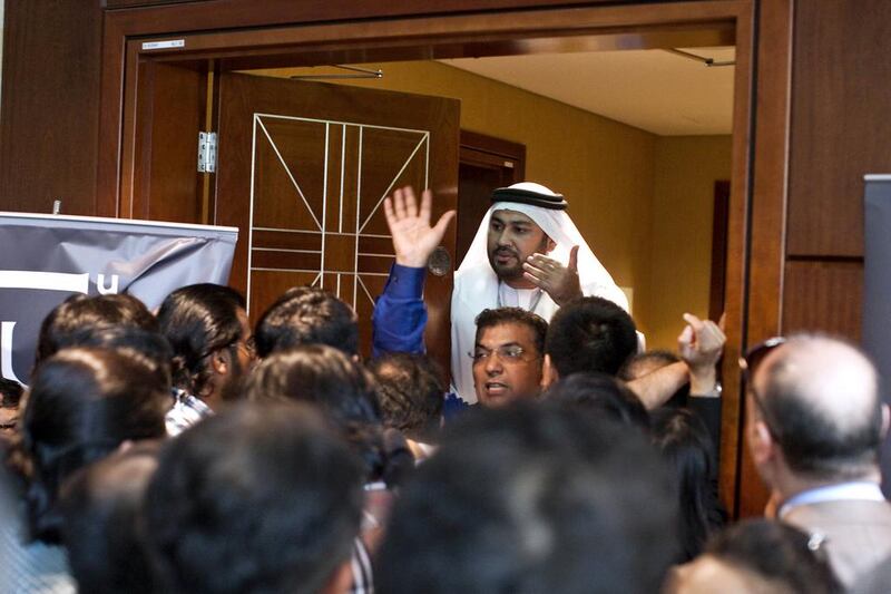 Buyers swarm and push against the doors of a room where Emaar is supposedly selling off-plan properties. Razan Alzayani / The National