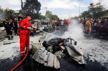 A firefighter inspects the scene of a car bomb attack in Baghdad on April 15, 2021. Reuters