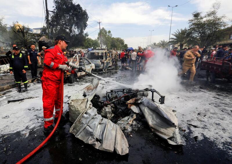 FILE PHOTO: A firefighter inspects the site of a car bomb attack in Sadr City district of Baghdad, Iraq April 15, 2021. REUTERS/Wissam al-Okili/File Photo