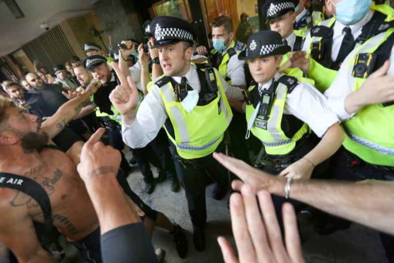 Police officers stop protesters from accessing Studioworks during the demonstration. Protesters gathered outside Studioworks to show their dismay against the BBC media bias. Getty Images