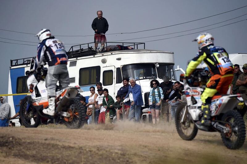 People watch motorcycle competitors during the first stage of the 2015 Dakar Rally in Argentina on Sunday. Franck Fife / AFP